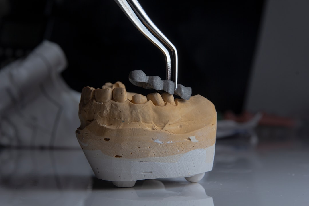 a model of a tooth with a toothbrush in it